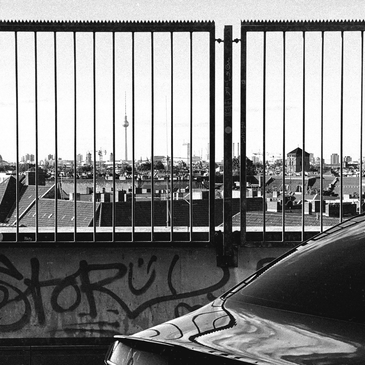 Berlin skyline and television tower seen through a metal railing